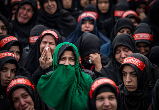 Shia Muslim women mourn and crying during Asura Istanbul, Turkey - November 13, 2013:  Shia Muslim women mourn and crying during Asura.  Asura is a religious observance marked every year by Muslims to commemorate the martyrdom of Imam Hussein, a grandson of the Prophet Mohammed, in the Iraqi city of Karbala in the seventh century.  The word 'asura literally means "10th," as it is on the 10th day of Muharram, the first month of the Islamic year day of ashura stock pictures, royalty-free photos & images