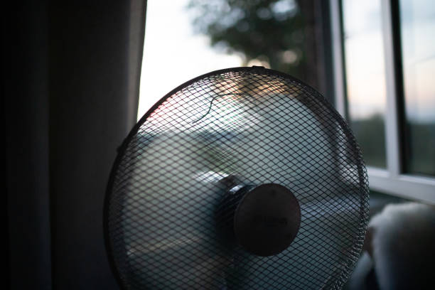 istock Cooling fan in the light hot summer night by the open window. 1334152956