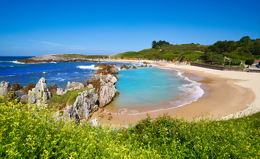 Picturesque golden sand beach and clear turquoise waters at Cala Mesquida beach in eastern Majorca