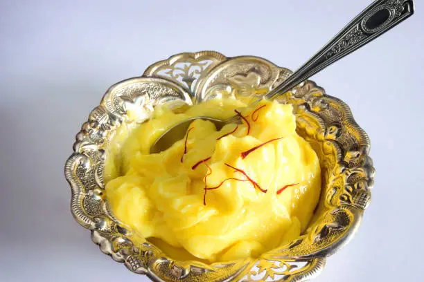 Photo of Shrikhand, a traditional Indian dessert prepared from thick, creamy, sweet strained curd or yogurt.