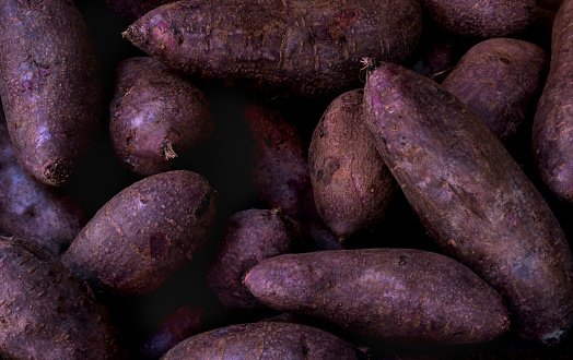 close up of a retail display of a pile of purple yams for sale by a street vendor in Chinatown, Manhattan, NYC
