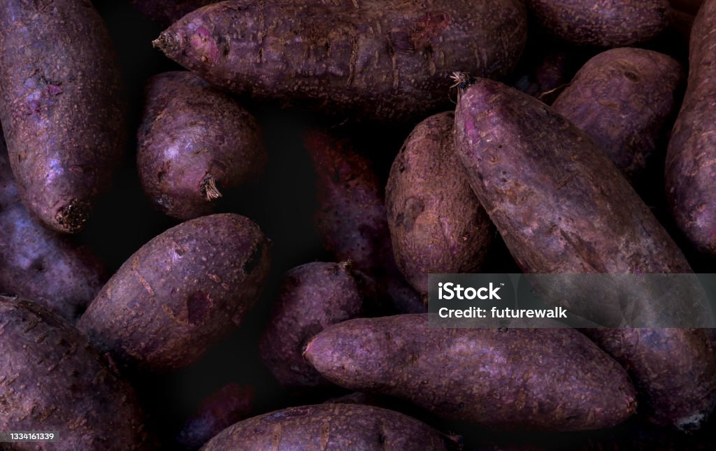 purple yams for sale at a market close up of a retail display of a pile of purple yams for sale by a street vendor in Chinatown, Manhattan, NYC Purple Yam Stock Photo