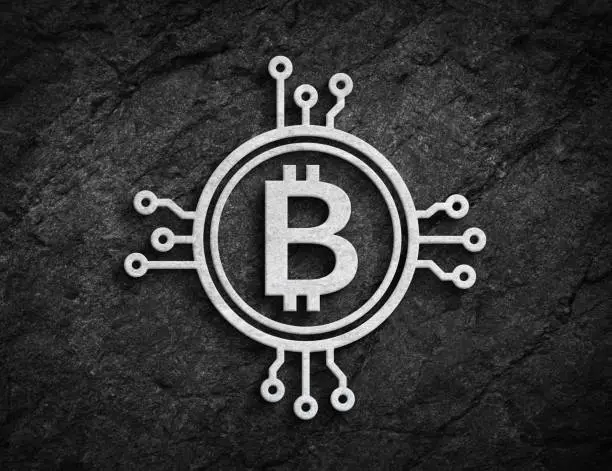 Photo of Bitcoin stone coin circuit symbol rock wall background