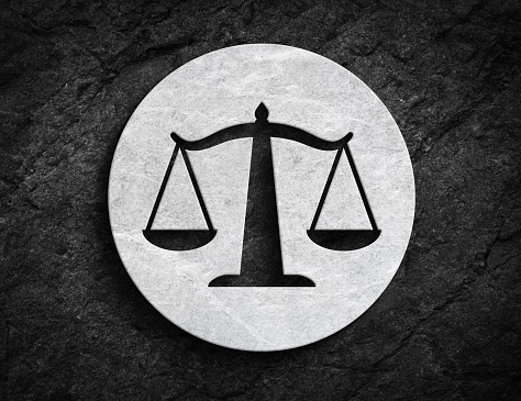 Scale symbol for justice fairness and balance symbol on dark stone wall background