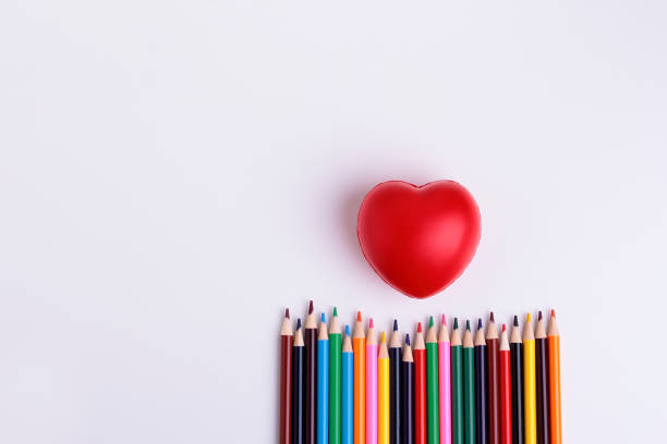 Decorative squishy heart  and  coloor pencils for baby development on white background.