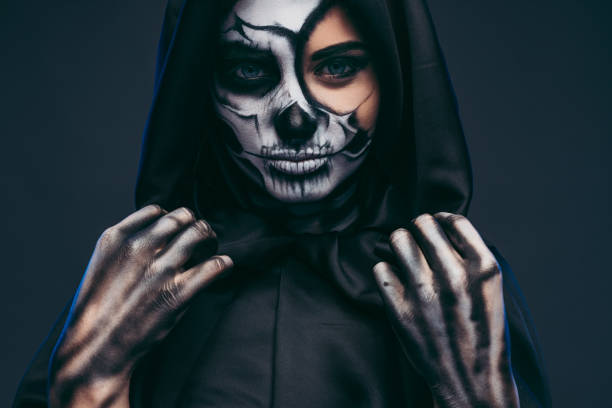 istock Mysterious woman adjusting black hood 1334184908