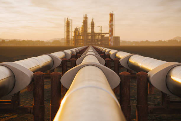 Oil Refinery And Pipeline In Desert During Sunset Steel oil pipes from refinery in desert during sunset. oil industry stock pictures, royalty-free photos & images