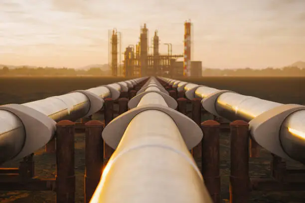 Photo of Oil Refinery And Pipeline In Desert During Sunset