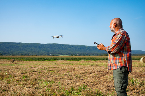 A farmer using a drone to check his fields