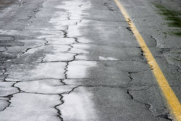 Wet and Cracked Street detail in bad and wet condition bumpy stock pictures, royalty-free photos & images