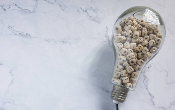 istock light bulb and alphabet wood cube on white marble for idea or think concept 1334202485