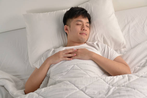 istock Handsome Young Asian man sleeping in bed 1334208652