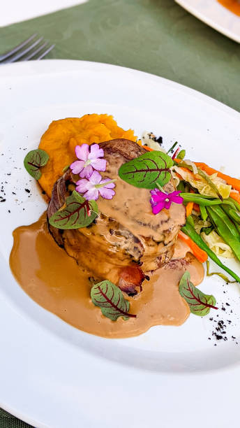 istock Bacon Wrapped Tenderloin With Au Jus and Veggies 1334209770