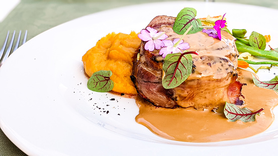 Bacon Wrapped Steak served with sweet potatoes puree