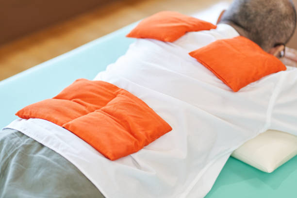 istock Elderly people who warm their shoulders and hips with a hot pack 1334210320