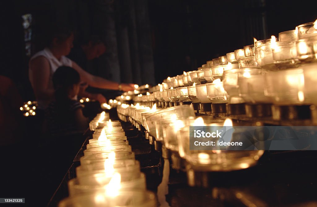 Lighting Prayers Faithful Family giving offering candles Candle Stock Photo