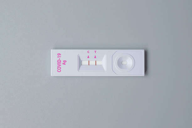istock Rapid Antigen Test kit with Positive result during swab COVID-19 testing. Coronavirus Self nasal or Home test, Lockdown and Home Isolation concept 1334213998