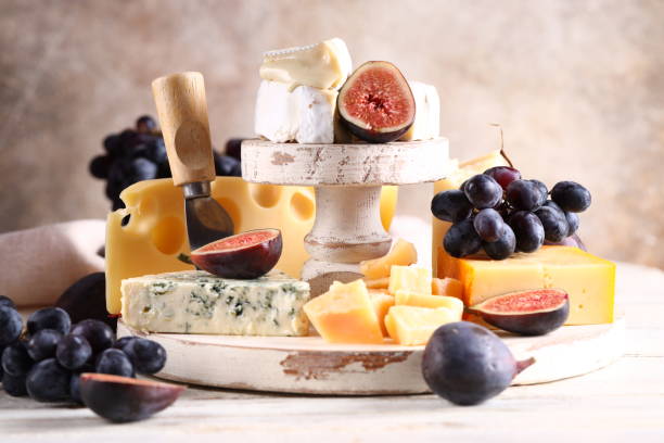 assortment of cheese assortment of cheese, camembert and parmesan on wooden background plate fig blue cheese cheese stock pictures, royalty-free photos & images