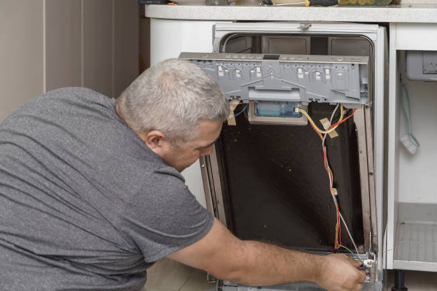 istock echnician or plumber repairing the dishwasher in a household 1334224310