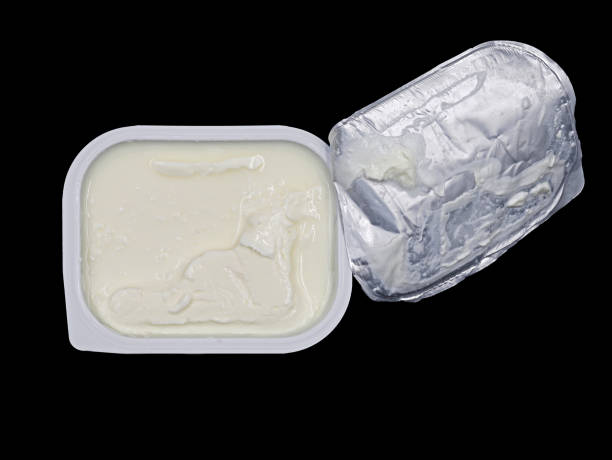 istock top view of quark or cream cheese in white plastic container isolated on black background 1334229083