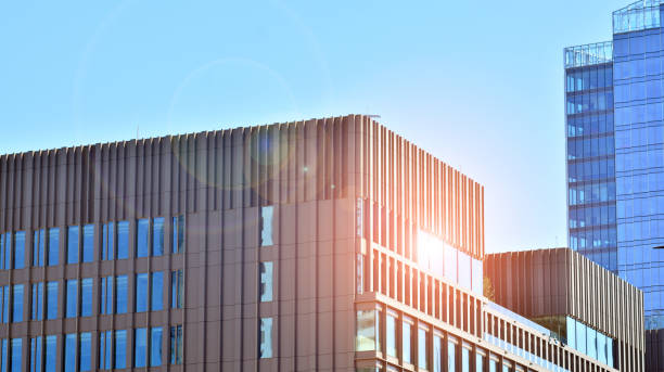 istock View of office building with glass wall under blue sky. 1334232637