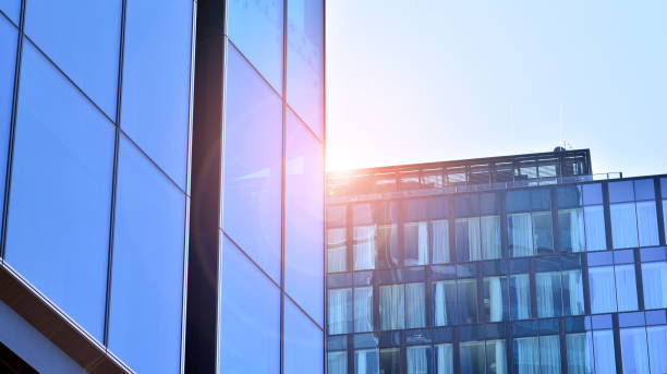 istock View of office building with glass wall under blue sky. 1334232648