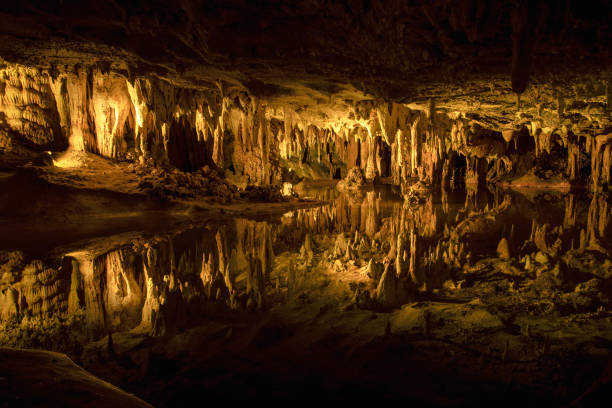 istock Underground water lake in cavern reflects stalactites and cave rock formations 1334236186