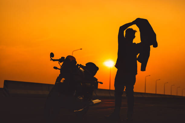 istock Motorcycle On The Way Back On A Summer Trip, Silhouette Man Riding A Motorcycle, Freedom Concept. 1334237764