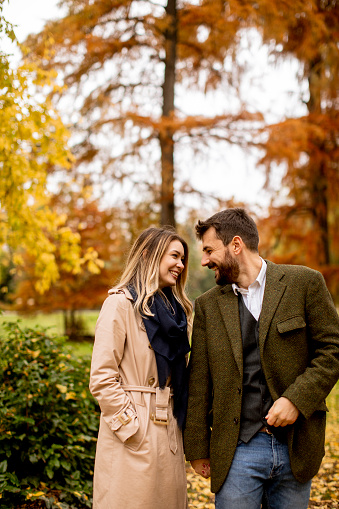 Handsome young couple in the autumn park