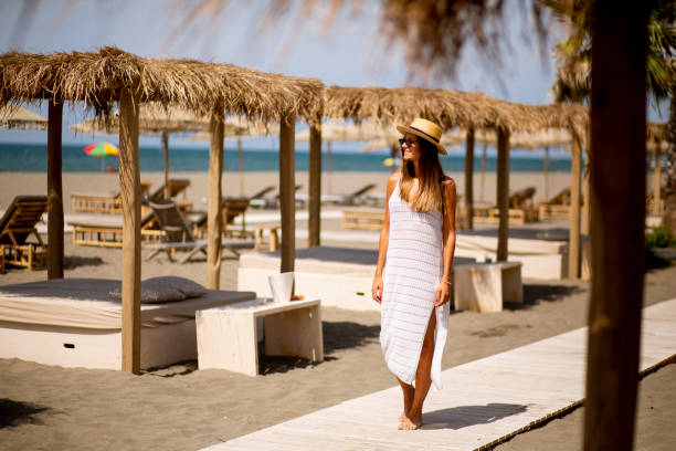 istock Young woman walking on a beach at summer 1334241845