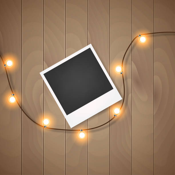 istock Photo frame with christmas lights on wooden background Vector 1334243522