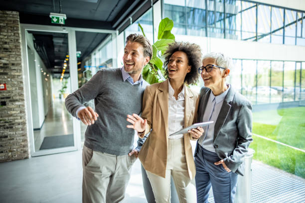 istock Business people using digital tablet in the lobby 1334246887