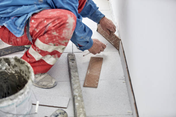 istock Ceramics tile man worker placing new tiles on the floor and wall. 1334246992