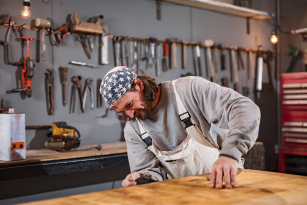 istock Male carpenter working on old wood in a retro vintage workshop. 1334247127