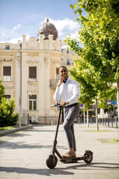 istock Young African American using electric scooter on a street 1334247571