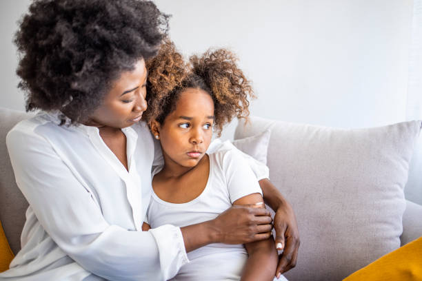 Loving mother consoling Loving mother consoling or trying make peace with insulted upset stubborn kid daughter avoiding talk, sad sulky resentful girl pouting ignoring caring mom embracing showing support to offended child black mother and adult daughter stock pictures, royalty-free photos & images