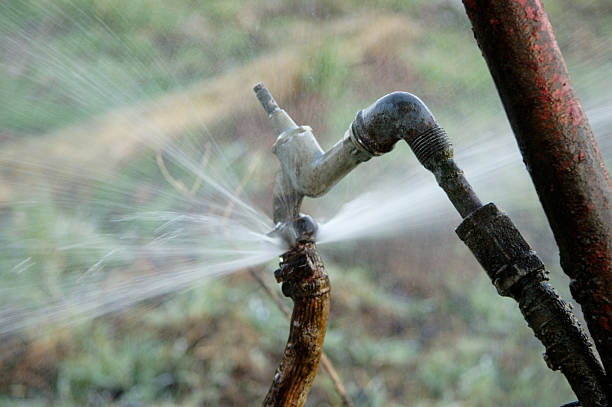 Pressure Gushing Water gushing faucet on field faucet leaking pipe water stock pictures, royalty-free photos & images