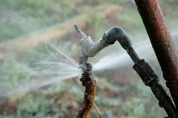 Water gushing faucet on field