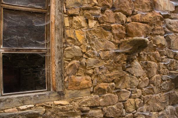 istock Old stone house wall Halloween style with spider webs 1334251919