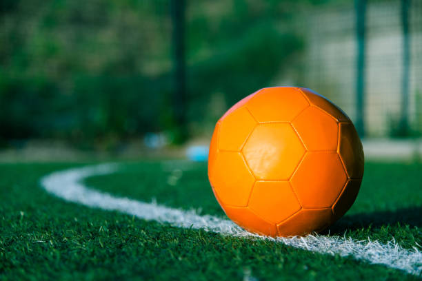 Orange soccer ball on the field of play