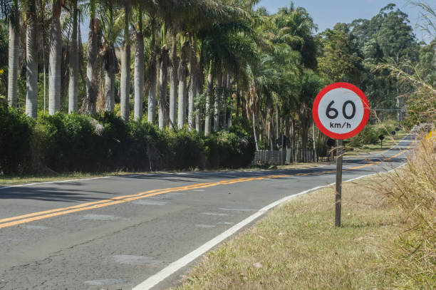 istock 60 km per hour, signpost written on a sign that is on a road, copy space on the left 1334256136