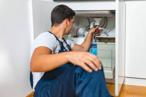 istock Male Plumber Fixing Sink Pipe In Kitchen 1334258257