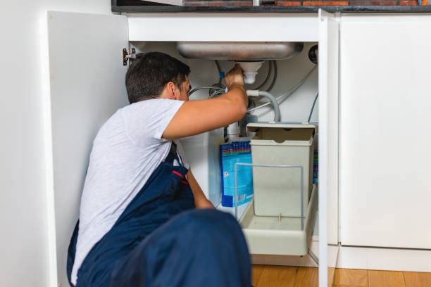 istock Male Plumber Fixing Sink Pipe In Kitchen 1334258261