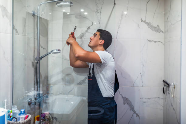 istock Installing a new shower hose on an used showerhead 1334258273
