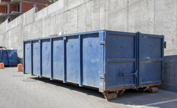 istock Metal durable blue industrial trash bin for outdoor trash at construction site. Large waste basket for household or industrial waste. A pile of waste 1334259525