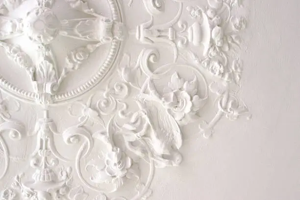 Ceiling part in rich stucco decor. Used to be decor element for a light fixture or luster.