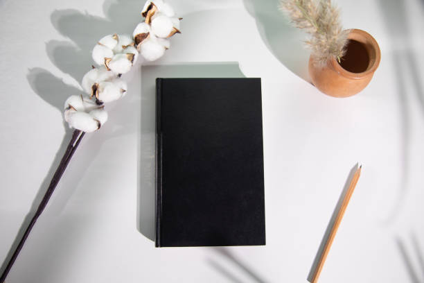 istock book and cotton branch on table 1334261030