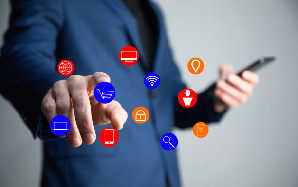 istock man holding phone with online icons 1334261112