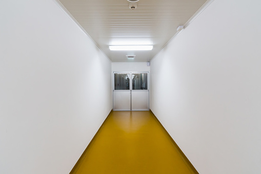 Interior worker corridor and aluminum door with Epoxy floor coating for cleanroom, Food Factory, Manufacturing Pharmaceutical Plant, Cosmetic Factory.