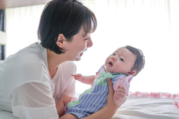 istock Mother singing lullaby for her bay to sleep 1334261811